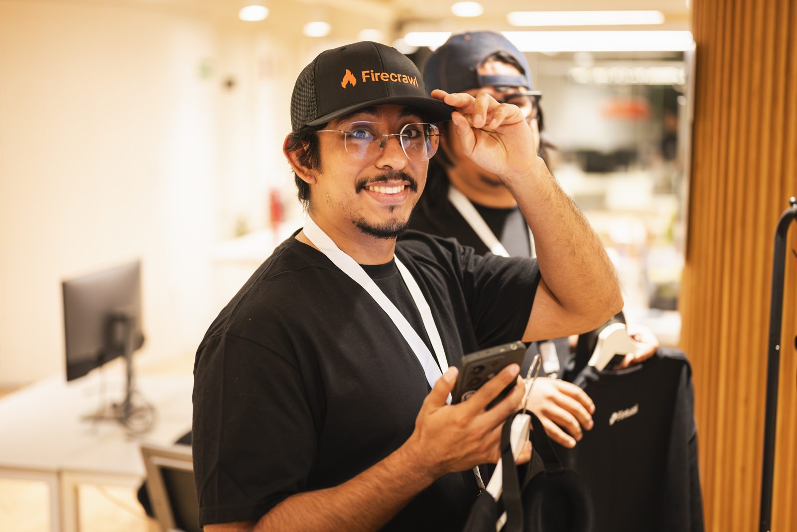 A hacker smiling in a brand-new Firecrawl cap
