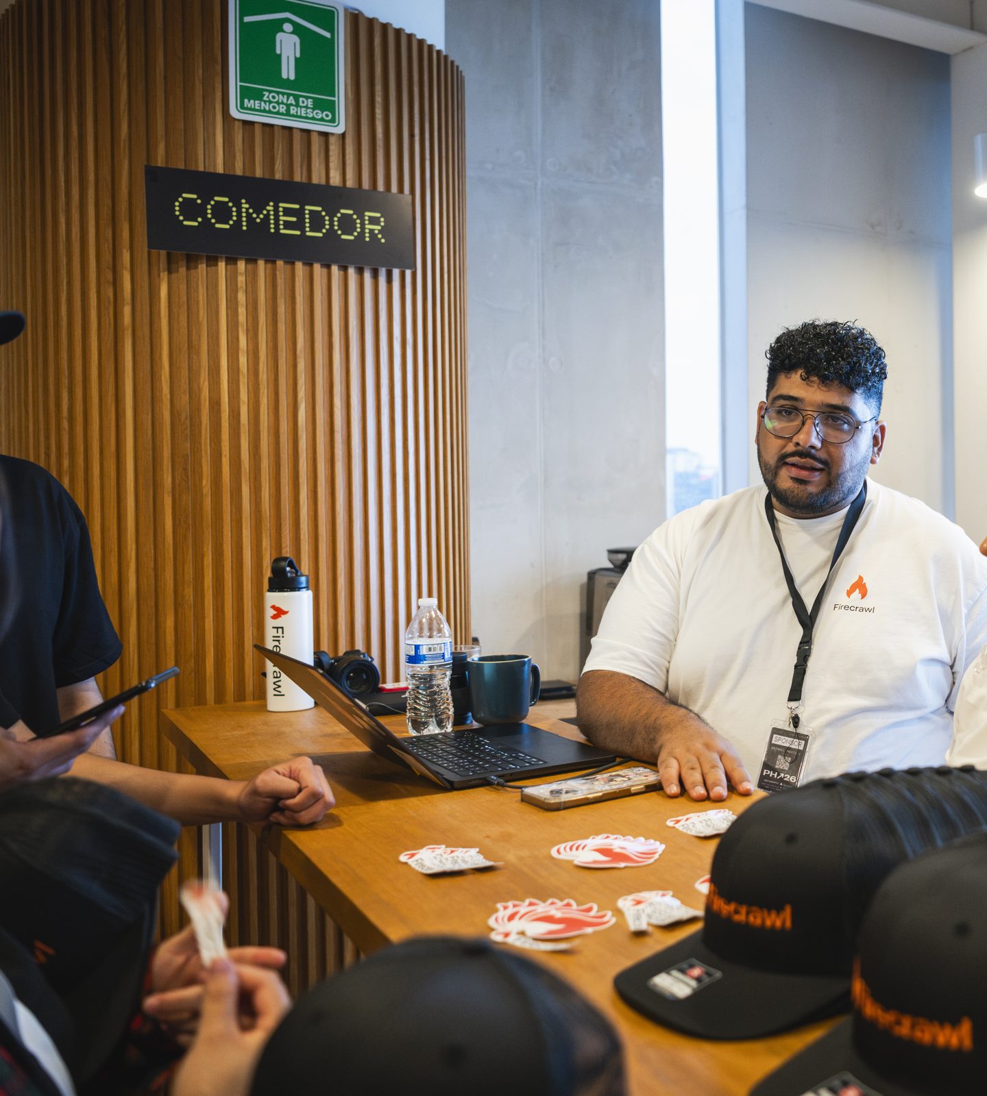 Talking with hackers at the Firecrawl table during Platanus Hack 26